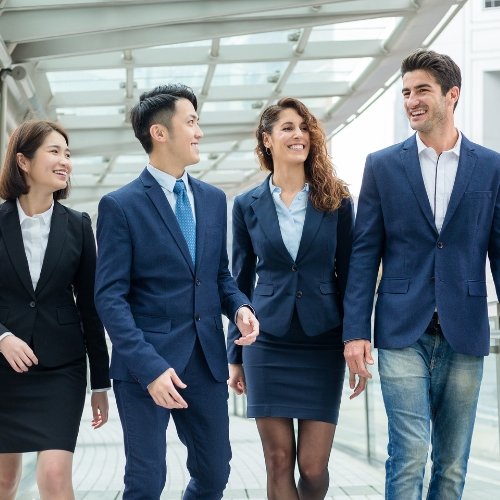 Business professionals walking around their company's HQ and chatting happily - Business English course for becoming a full-fledged professional.